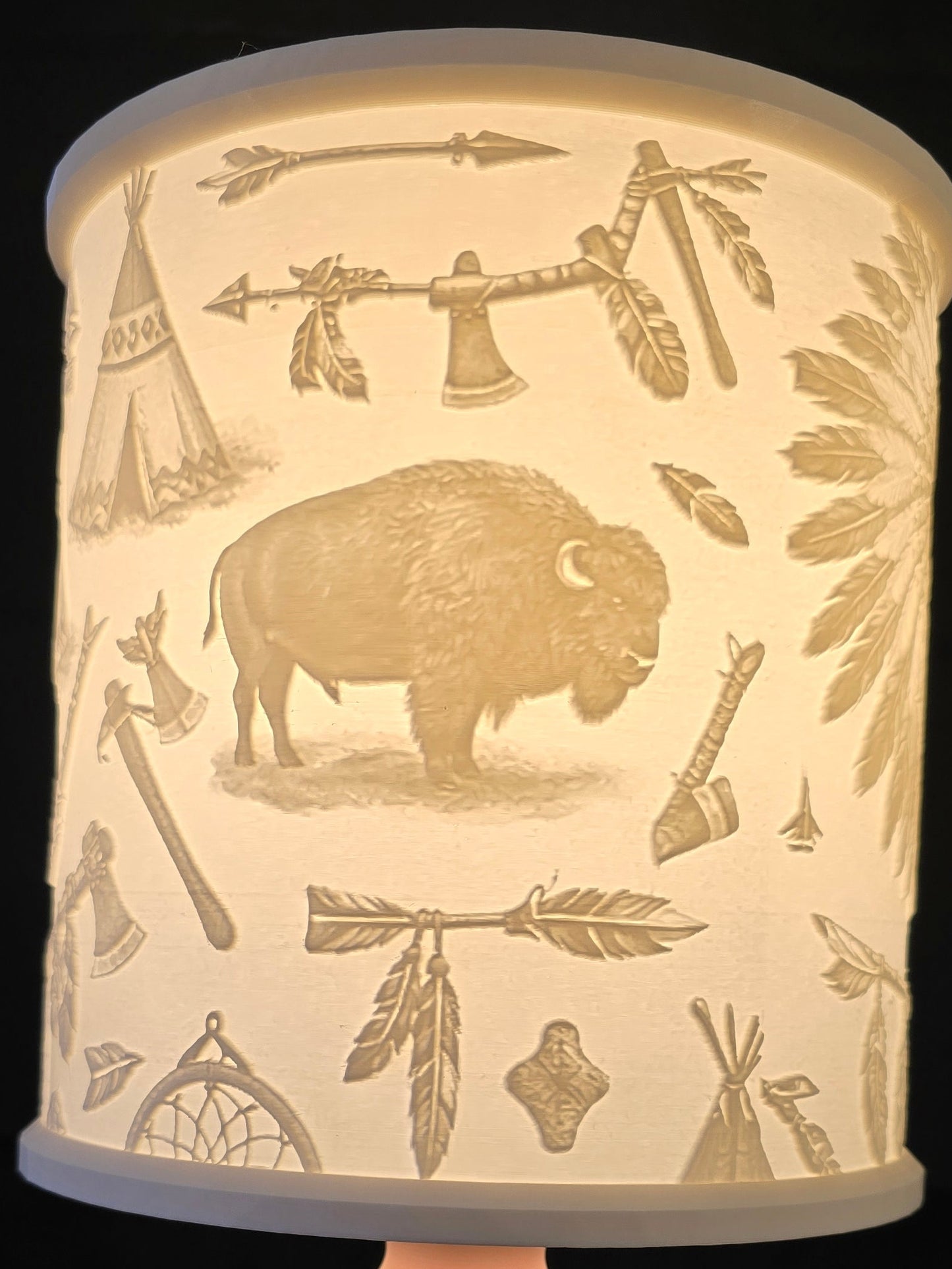 lampshade with a cylindrical white shade featuring buffalo and leaf patterns 