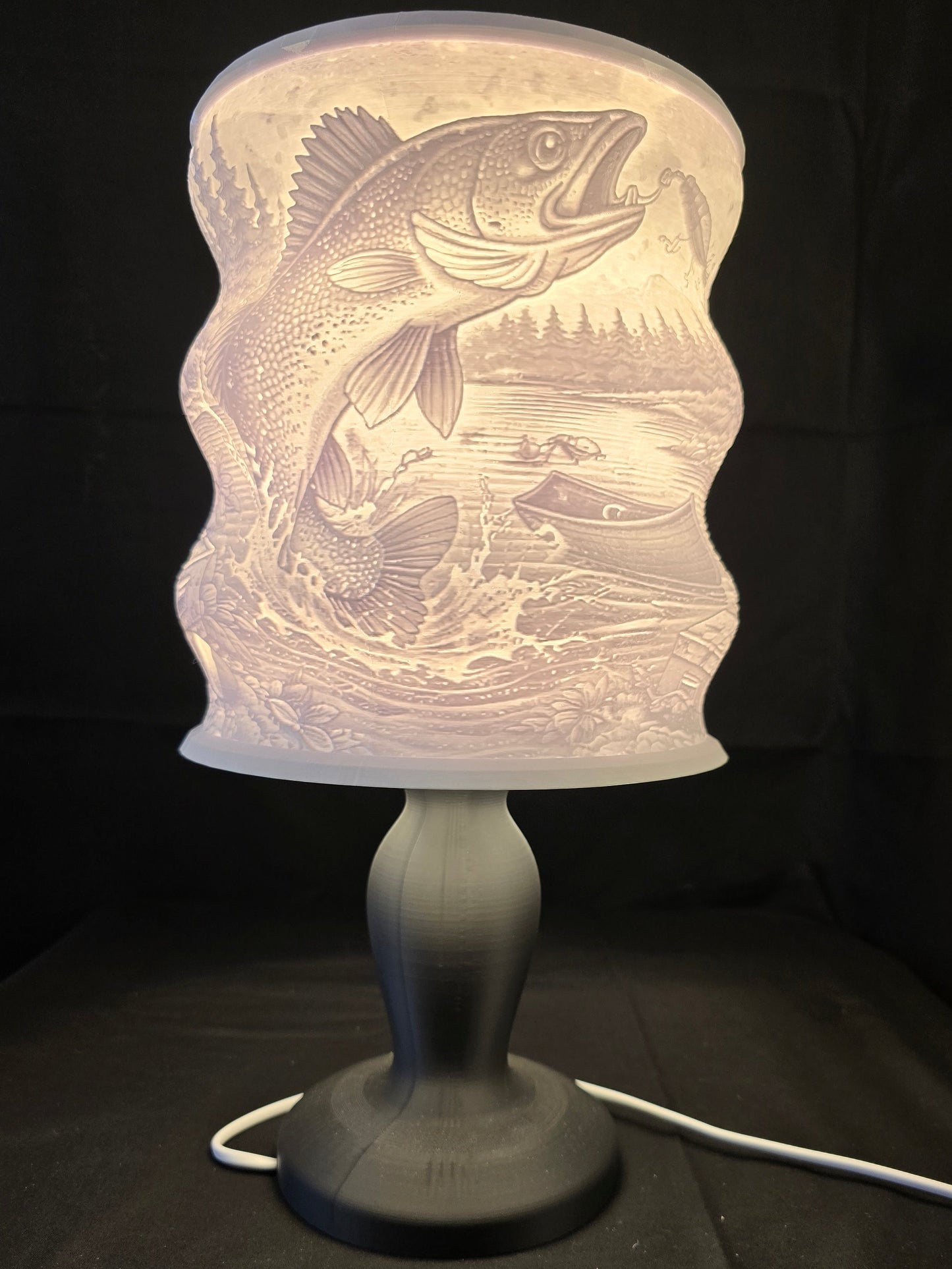 Decorative lamp with fish design on a black background