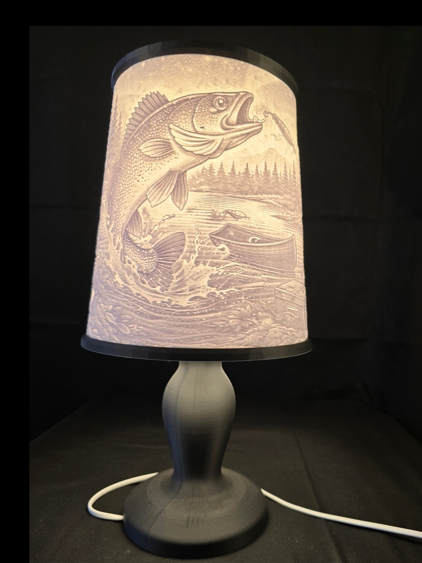 Decorative lamp with fish design on a dark background
